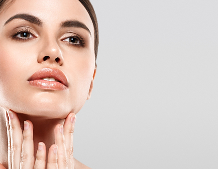 Woman Beauty portrait of attractive female. Skin care, cosmetics and makeup concept.Isolated on gray. Healthy perfect skin.の写真素材