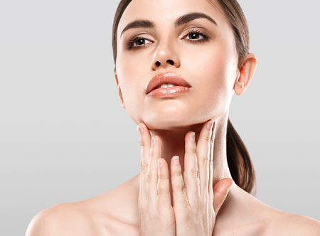 Woman Beauty portrait of attractive female. Skin care, cosmetics and makeup concept.Isolated on gray. Healthy perfect skin.の写真素材