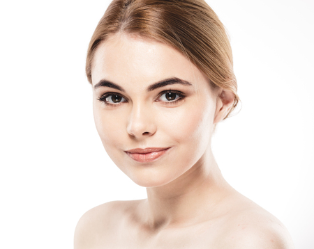 Woman studio portrait beautiful close-up with healthy skin happy isolated on whiteの写真素材