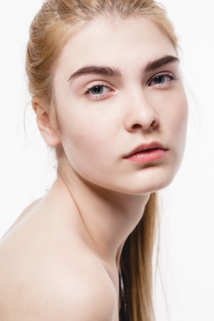 Amazing portrait of a beautiful young woman blond hair with perfect skin closeup. Studio shot.の写真素材