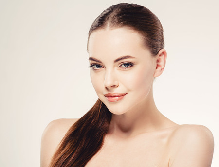 Beautiful woman face close up portrait young. Isolatedon white. Studio shot.の写真素材