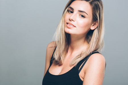 Beautiful young woman portrait smiling posing attractive blond. Studio shot.の写真素材