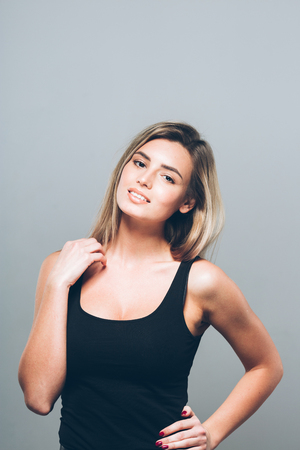 Beautiful young woman portrait smiling posing attractive blond. Studio shot.の写真素材