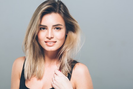 Beautiful young woman portrait smiling posing attractive blond. Studio shot.の写真素材