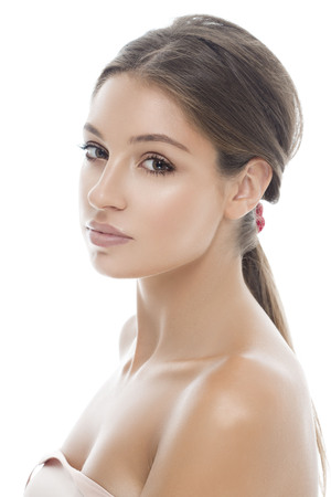 Beautiful woman face close up isolated on white. Studio shot.の写真素材