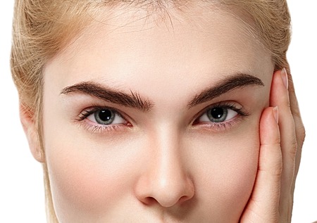 Eyes. Closeup shot of blonde woman eye with day makeup. Studio shot.の写真素材