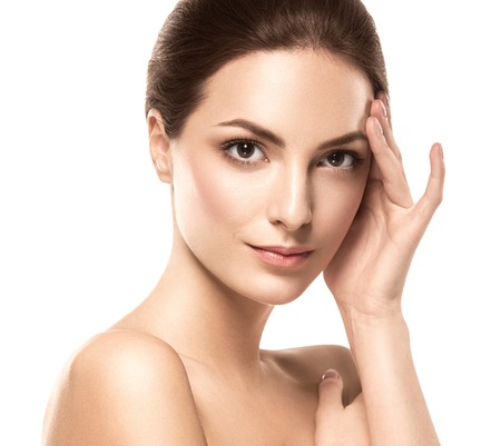 Beauty Woman face Portrait. Beautiful model Girl with Perfect Fresh Clean Skin. Brunette female looking at camera and smiling. Youth and Skin Care Concept. Isolated on a white backgroundの写真素材