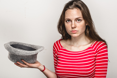 Woman portrait in hat hipster in stripes red clothes happy beautiful. Studio shot.の写真素材