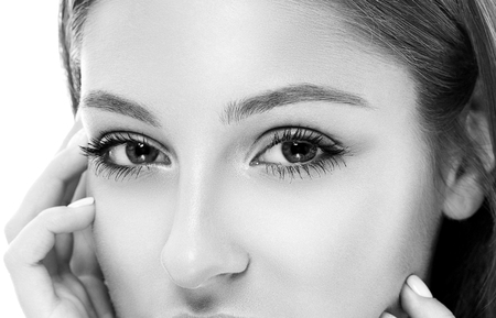 Woman eyes nose face close-up. Studio shot. Black and white. Isolated on white.の写真素材