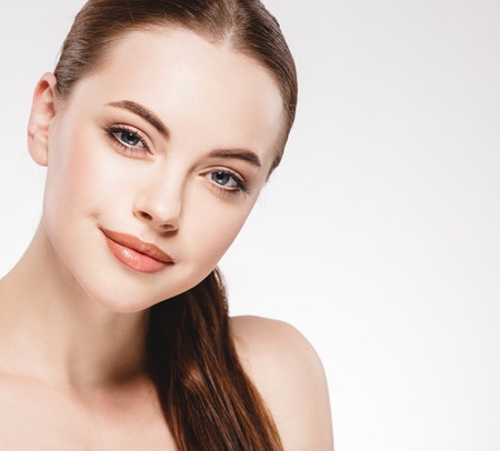 Beautiful woman face close up portrait. Studio shot. Isolated on white.の写真素材
