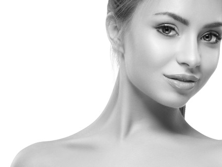Beautiful woman face close up on white black and white. Studio shot.の写真素材