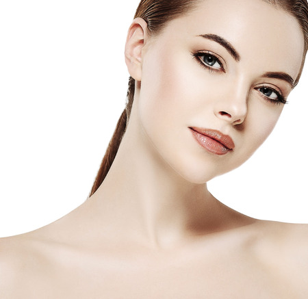 Beautiful woman face close up portrait young. Isolated on white. Studio shot.の写真素材