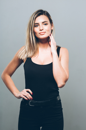 Beautiful young woman portrait smiling posing attractive blond. Studio shot.の写真素材