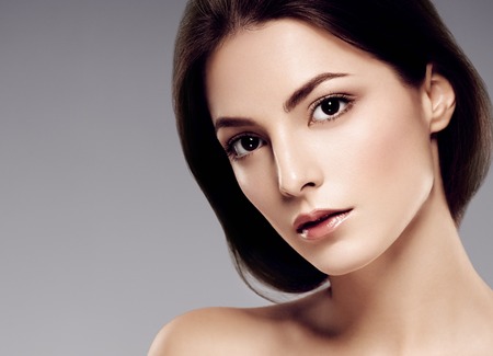Woman beauty face portrait with healthy skin. Studio shot.の写真素材