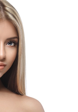 Beautiful woman portrait half-face isolated on white. Studio shot.の写真素材
