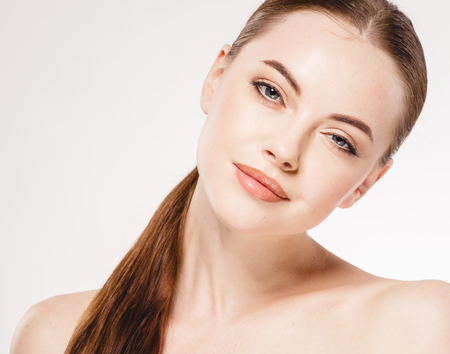 Beautiful woman face close up portrait. Studio shot. Isolated on white.の写真素材
