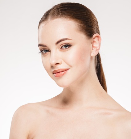 Beautiful woman face close up portrait. Studio shot. Isolated on white.の写真素材