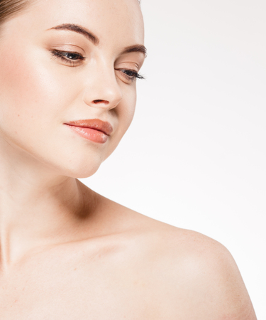 Beautiful woman face close up portrait. Studio shot. Isolated on white.の写真素材