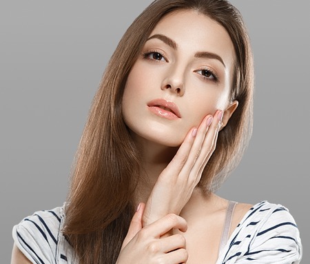 Woman beauty portrait studio closeup with healthy skin. Studio shot. Isolated on white.の写真素材