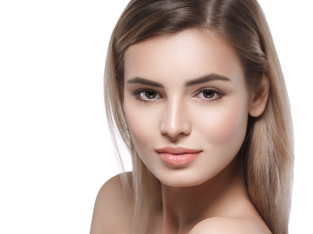 Beautiful woman face close up. Isolated on white. Studio shot.の写真素材