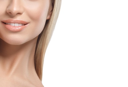 Lips shoulders chin nose smile Beautiful woman blond portrait face. Studio shotの写真素材