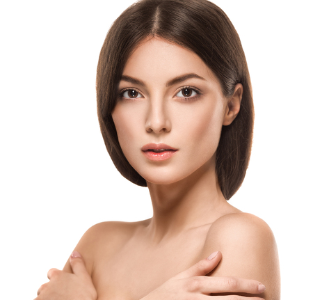 Beautiful woman face close up portrait young. Studio shot. Isolated on white.の写真素材