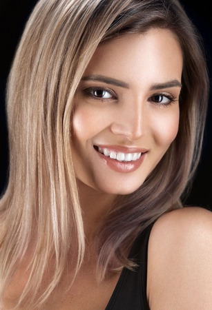Beautiful woman face close up portrait young. Isolatedon black. Studio shot.の写真素材