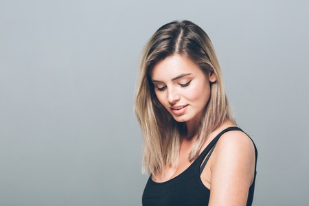 Beautiful young woman portrait smiling posing attractive blond. Studio shot.の写真素材