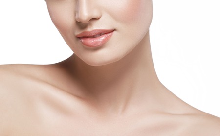Shoulders neck lips Beautiful woman face close up portrait young. Isolated on white. Studio shot.の写真素材