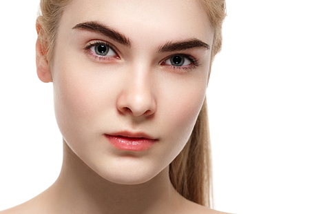 Amazing portrait of a beautiful young woman blond hair with perfect skin closeup. Studio shot.の写真素材