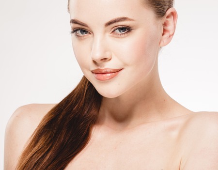 Beautiful woman face close up portrait. Studio shot. Isolated on white.の写真素材