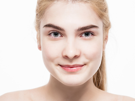 Amazing portrait of a beautiful young woman blond hair with perfect skin closeup. Studio shot.の写真素材