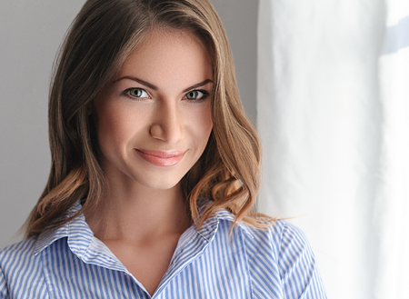 Young beautifull woman in blue shirt with sexy pink lips. Studio shot.の写真素材