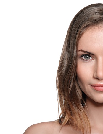 Young beautiful woman half face portrait with healthy skin. Studio portrait. Isolated on white.の写真素材