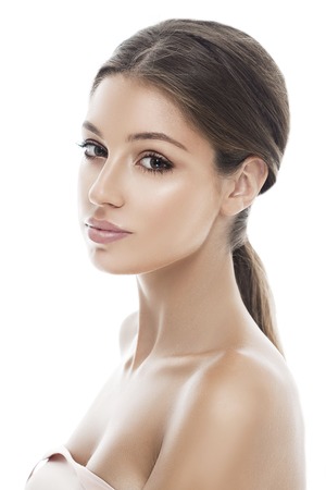 Beautiful woman face close up isolated on white. Studio shot.の写真素材