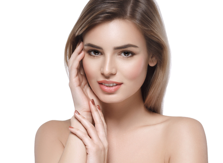 Beautiful woman face close up. Isolated on white. Studio shot.の写真素材