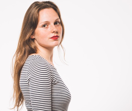 Woman portrait in stripes dress. Studio shot. Isolated on whiteの写真素材
