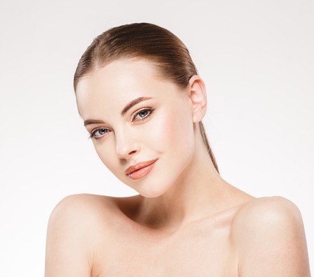 Beautiful woman face close up portrait. Studio shot. Isolated on white.の写真素材