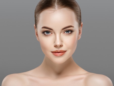 Beautiful woman portrait face. isolated on gray. Studio shot.の写真素材