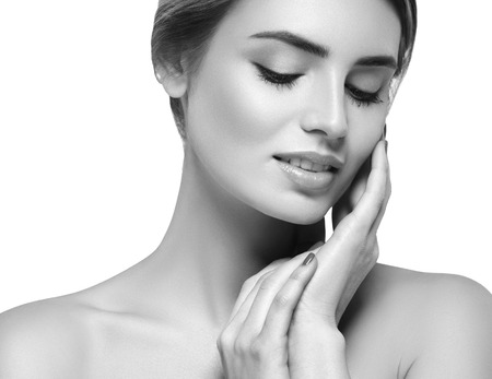Beautiful woman portrait face. Isolated on white. Black and white. Studio shot.の写真素材