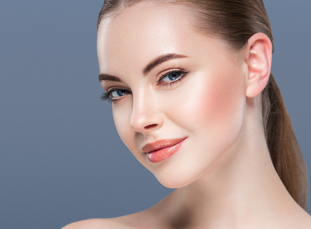 Woman beauty portrait skin care concept on blue background. Studio shot.