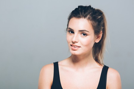 Beautiful young woman portrait smiling posing attractive blond. Studio shot.