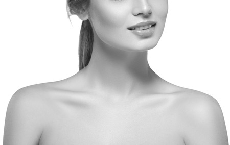 Shoulders neck chin hands Beautiful woman portrait face . isolated on white. black and white. Studio shot.の写真素材