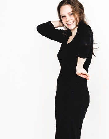 Woman portrait in black dress posing with long hair attractive. isolated on white. Studio shot.の写真素材