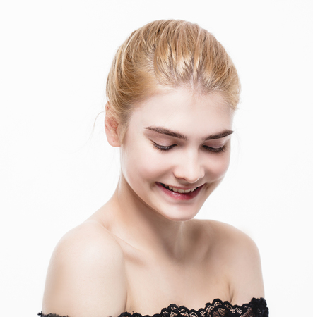 Amazing portrait of a beautiful young woman blond hair with perfect skin closeup. Studio shot.の写真素材