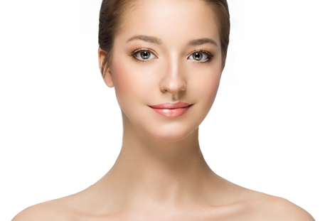Beautiful woman face close up portrait young. Isolated on white. Studio shot.の写真素材