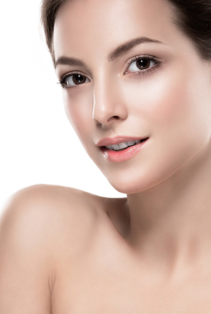 Beautiful woman face close up portrait. Isolated on white.  Studio shot.の写真素材