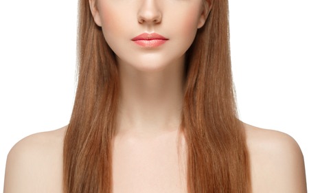 Beautiful woman face close up. Studio shot. Isolated on white.の写真素材