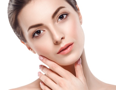 Young beautiful woman face portrait with healthy skin. Studio shot. Isolated on white.の写真素材