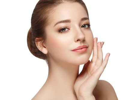 Young beautiful woman face portrait with healthy skin. Isolated on white. Studio shot.の写真素材